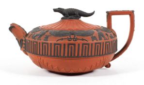 A Wedgwood Rosso Antico teapot and cover, 19th century, decorated with black Egyptian style cameos,