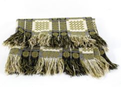 A Welsh blanket, in green, cream and black,