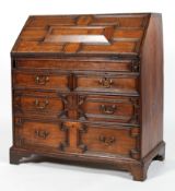 An 18th century oak fall front bureau, the front panelled with geometric mouldings,