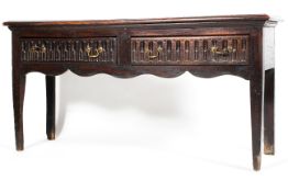 An 18th century oak dresser base, with two short drawers carved with recessed flutes,