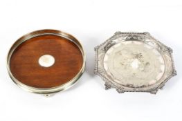 A large early 20th century silver plated decanter coaster, of circular form, with mahogany base,
