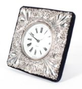 A silver framed desk clock, embossed with scrolls and palmettes, 20th century, quartz movement,