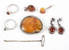 A collection of reconstructed amber jewellery consisting of rings, earrings, pendant and a brooch.