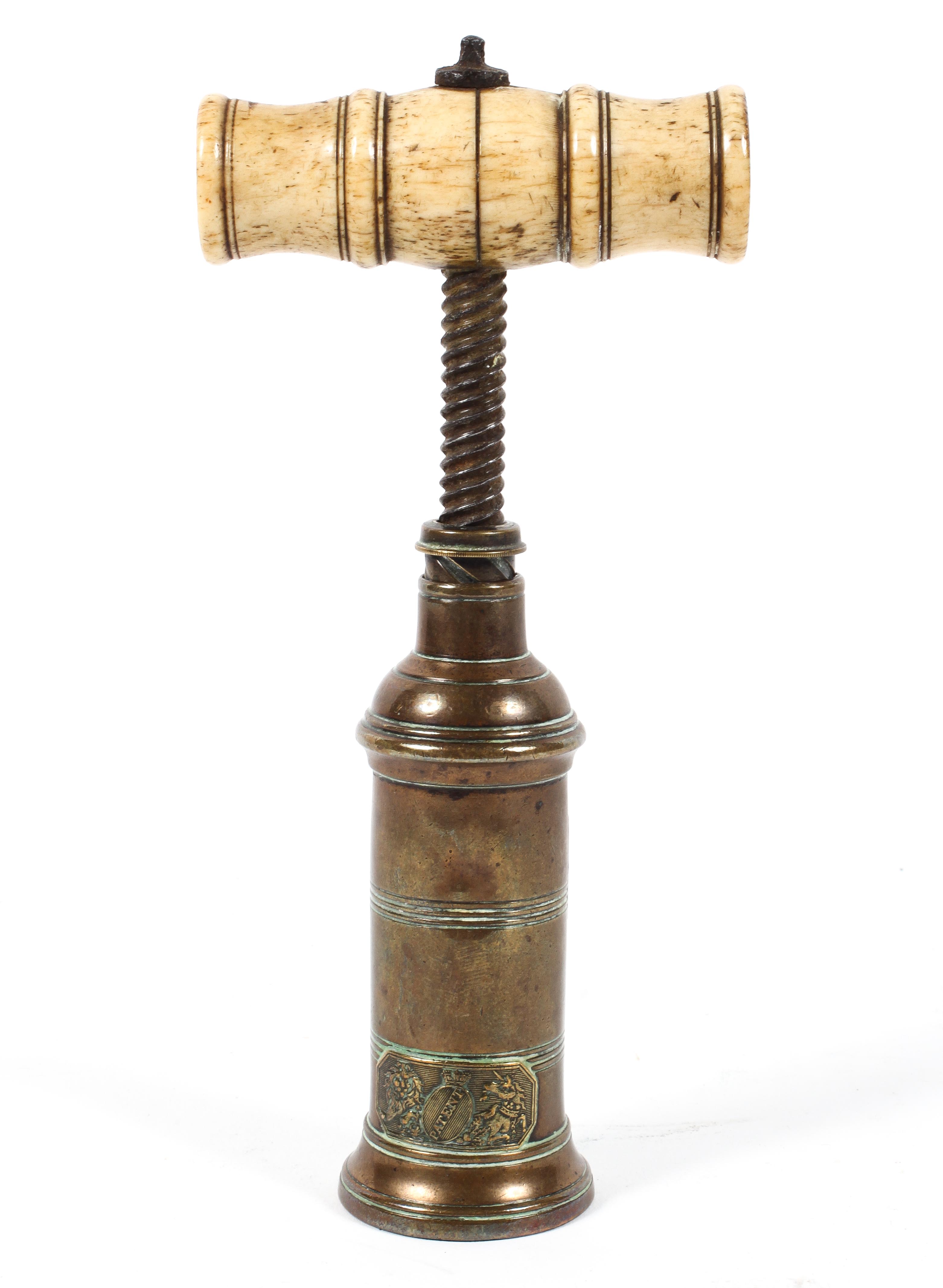 A Georgian brass and ivory mounted corkscrew, applied with a 'patent' Royal Arms plaque,