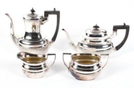 An Edwardian four piece EPNS tea service, in the Georgian style, of reeded form,
