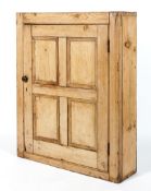 A Victorian pine wall cupboard, with a four panelled door,