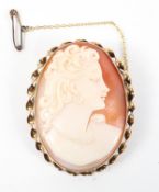 A yellow metal carved cameo brooch encased in a rope twist mount