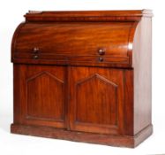 A Victorian mahogany roll top bureau, the top enclosing a fitted, sliding interior,