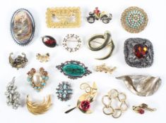 A collection of twenty costume brooches of various designs.