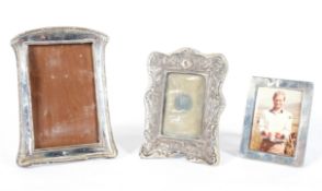 Three silver photo frames, including: a Victorian embossed rococo frame, with velvet back,