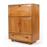 An Ercol blonde elm bureau cupboard,