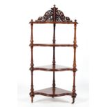 A Victorian corner four tier whatnot, of serpentine outline,