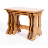 An Ercol blonde elm nest of three occasional tables, of rectangular form,