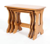 An Ercol blonde elm nest of three occasional tables, of rectangular form,