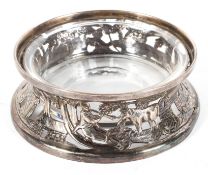 An Irish silver ashtray with glass liner, hallmarked for Dublin, 1922, pierced with rural figures,