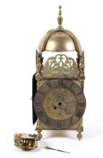 A brass lantern clock, of traditional form with pierced foliate ornament, the movement loose,