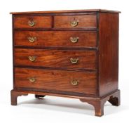 A George III mahogany chest of drawers, with two short drawers above three graduated drawers,