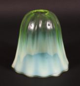 A vaseline glass lamp shade, circa 1900, of tapering lobed form and graduated yellow tint,