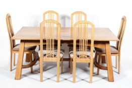 An Arts and Crafts style oak dining table and six dining chairs,