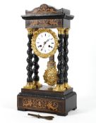 An ebonised and inlaid portico style mantel clock,