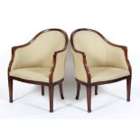 A pair of 19th century mahogany tub chairs, with arched back and scroll carved arm rests,