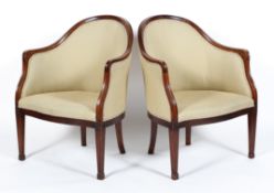A pair of 19th century mahogany tub chairs, with arched back and scroll carved arm rests,