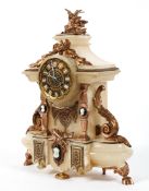 An alabaster mantel clock, with a gothic style dial,
