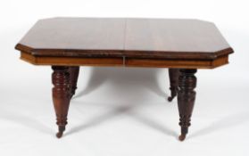 A late Victorian oak extending dining table, of canted rectangular form,