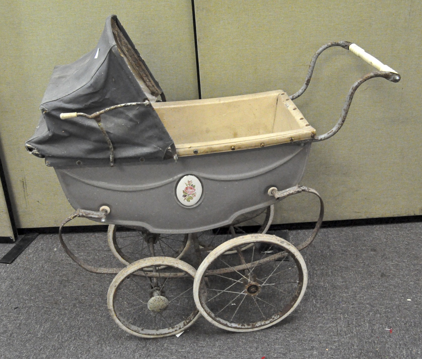 A Silver Cross Dolls pram, with navy blue cover and hood, the grey sides with floral inset plaques,
