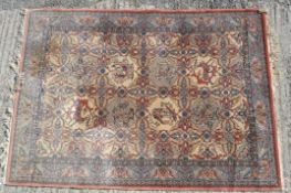 A 20th century rug, the cream rug woven with red and orange floral design,