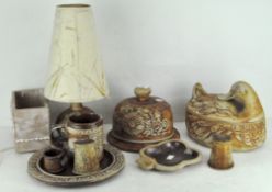 A group of Quantock stoneware table items including a cheese dome, duck casserole,
