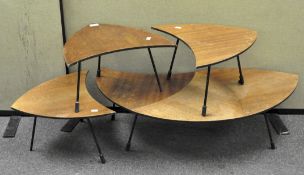 A nest of three retro tables with wooden tops and black metal legs,