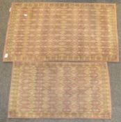 Two small Eastern woven mats, with yellow and gold geometric patterns on a red ground,
