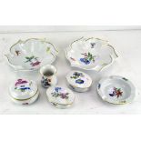 A 20th century collection of three Meissen ashtrays, a miniature vase and three lidded boxes,