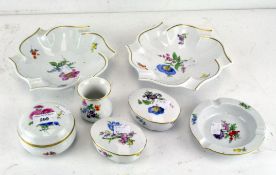 A 20th century collection of three Meissen ashtrays, a miniature vase and three lidded boxes,