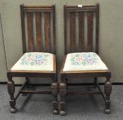 A pair of early 20th century high backed dining chairs with simple flat back splats