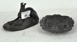 An early 20th century Spelter figure of a greyhound/whippet playing with a ball, 8cm high,