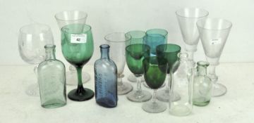 A selection of wine glasses and bottles in assorted shapes, sizes and colours,