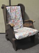A mid 20th century oak lambing chair, pegged construction,