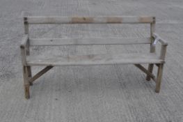 A wooden garden bench oif plank construction,