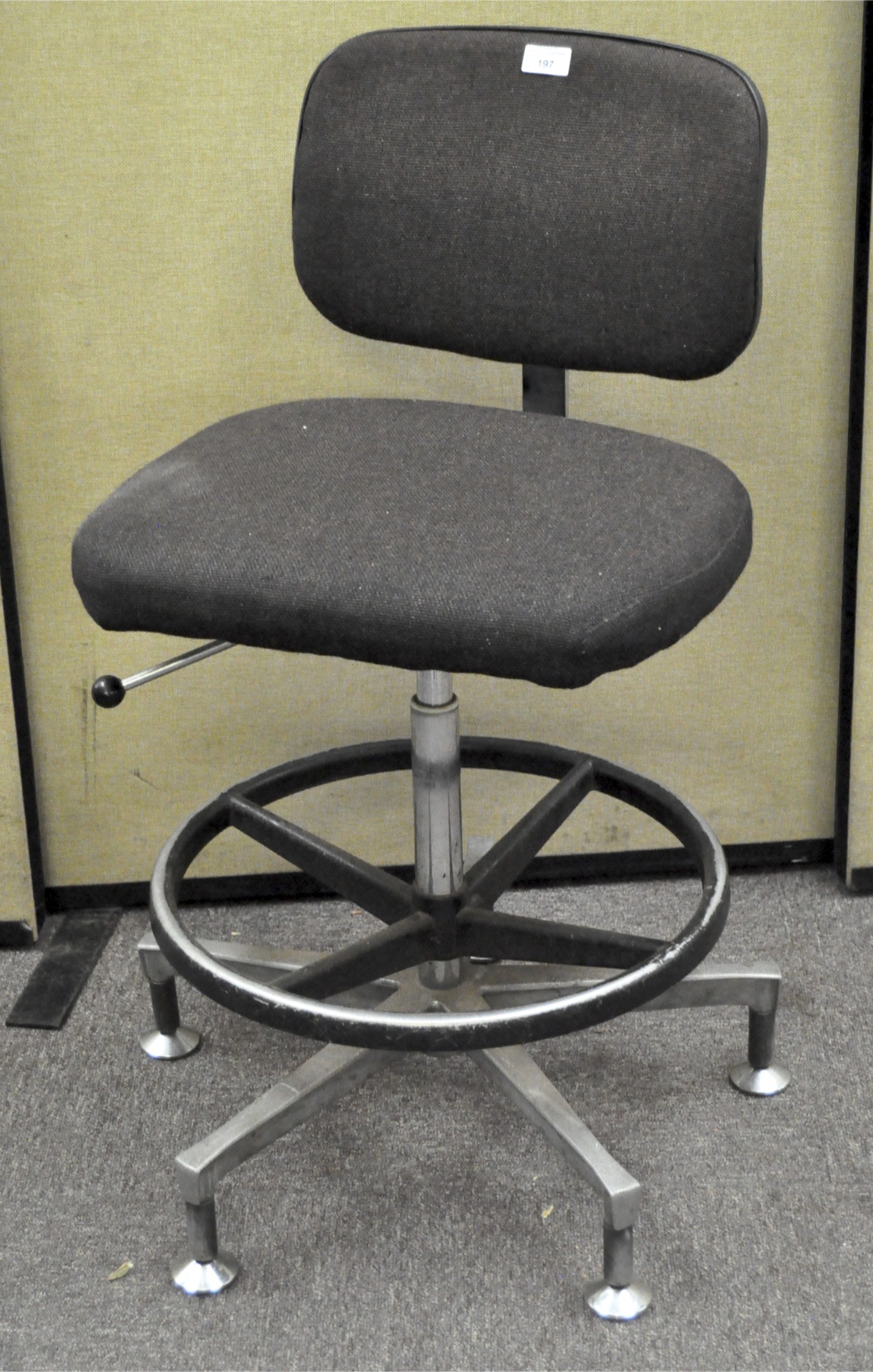 A retro style swivel chair, upholstered in grey fabric with on metal frame,