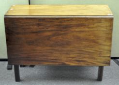 A 19th century drop leaf mahogany dIning table on chamfered square legs,