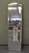 A full length wall mirror with bevelled edge,