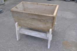 A pine wooden trough on stand,