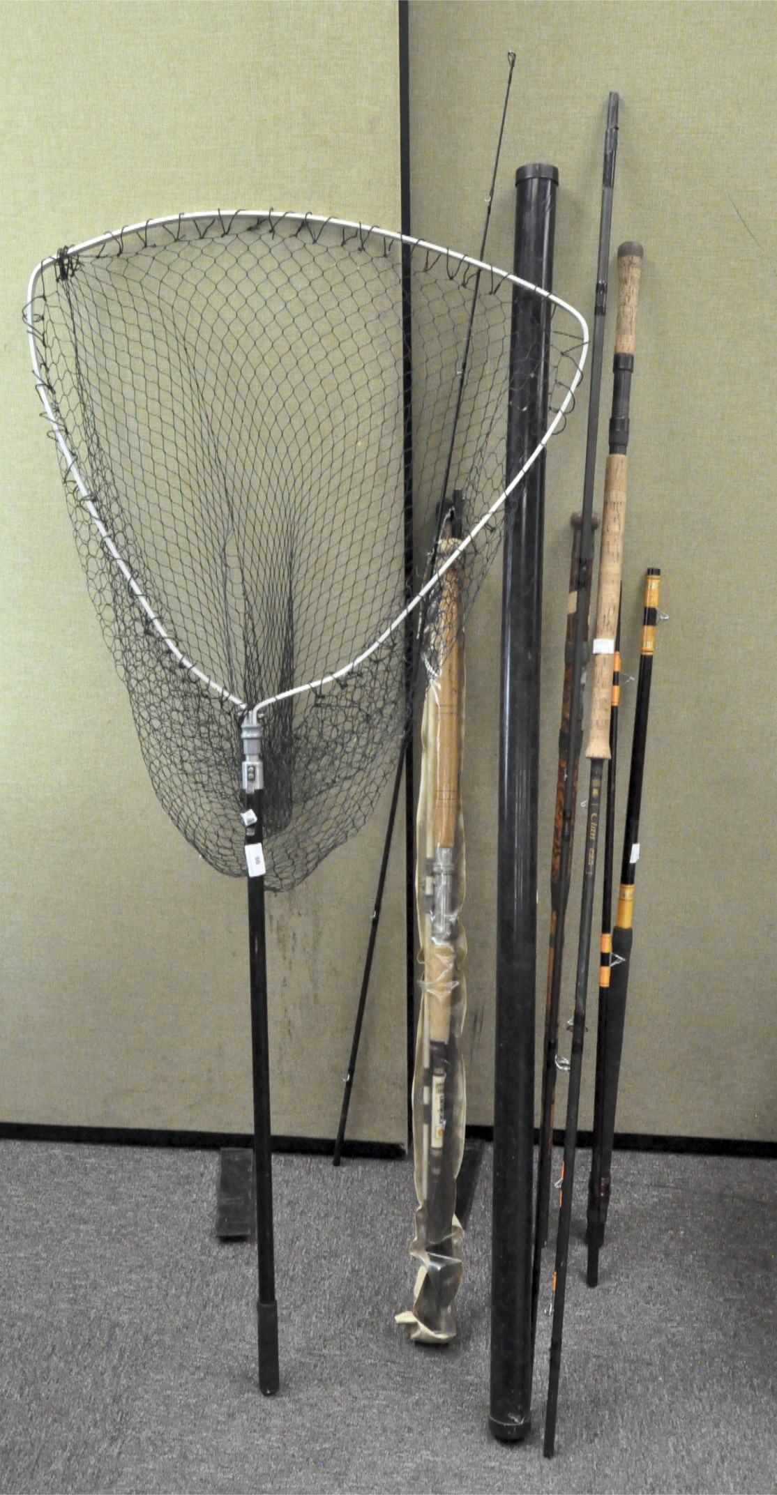 A quantity of assorted fishing rods and landing nets,