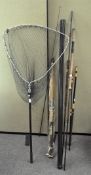 A quantity of assorted fishing rods and landing nets,