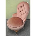 A pink velvet upholstered button back armchair,