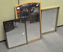 Three framed mirrors, two with bevelled edges, one with an arched top oak frame,