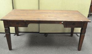 A large wooden desk, the rectangular top with metal handled drawers either side,