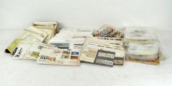A collection of stamps and postcards, first day editions, some loose in packets,